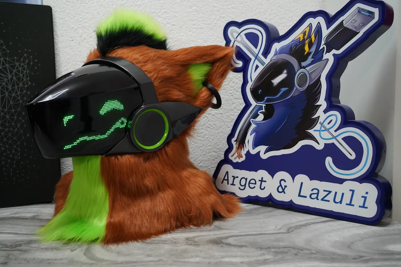 Rust brown Protogen head with a lime green mane, green pixel eyes and a jagged mouth on the black LED visor
