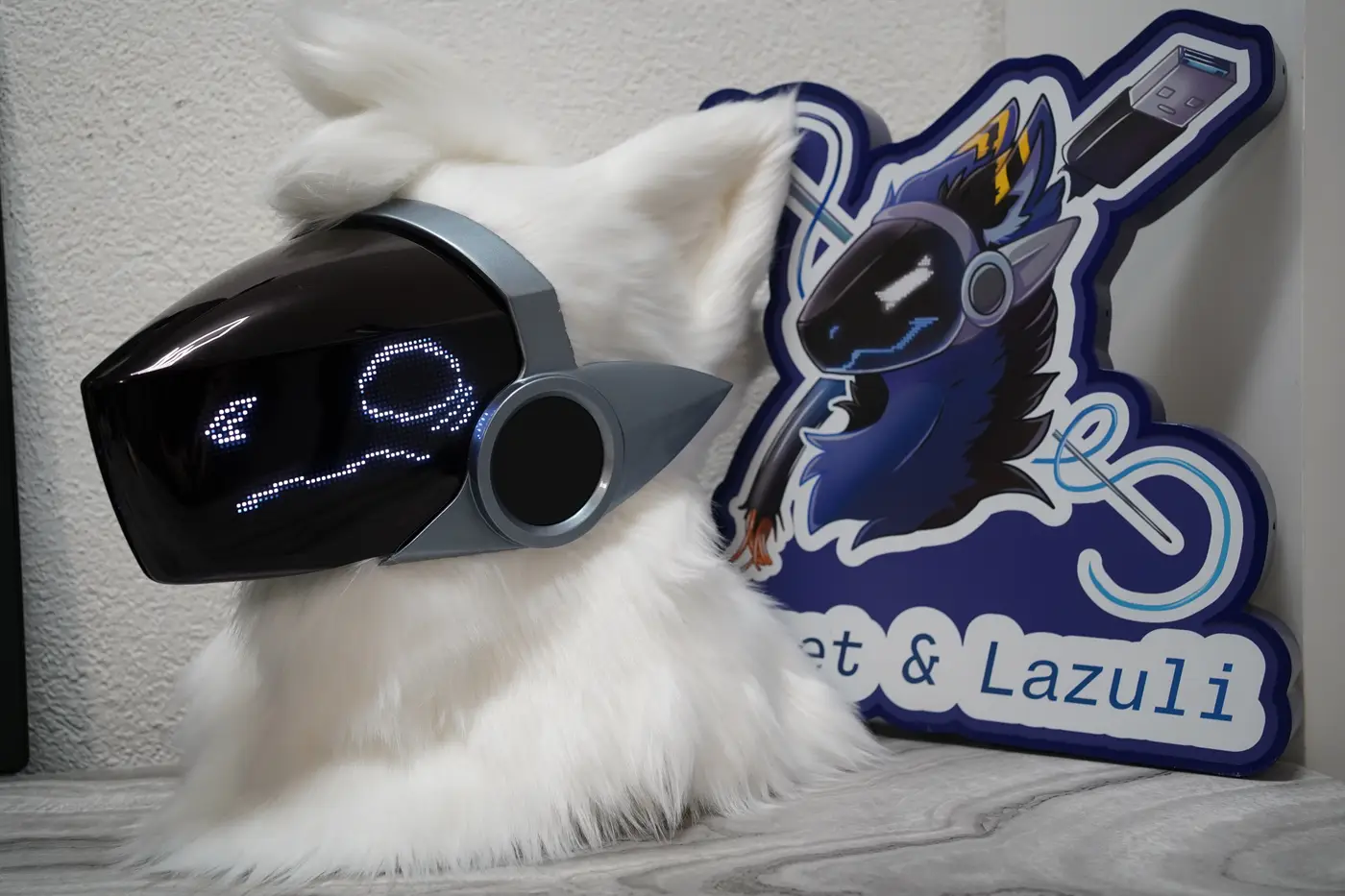 White Protogen head with a gray shell, white pixel eyes and a thin wavy mouth on the black LED visor