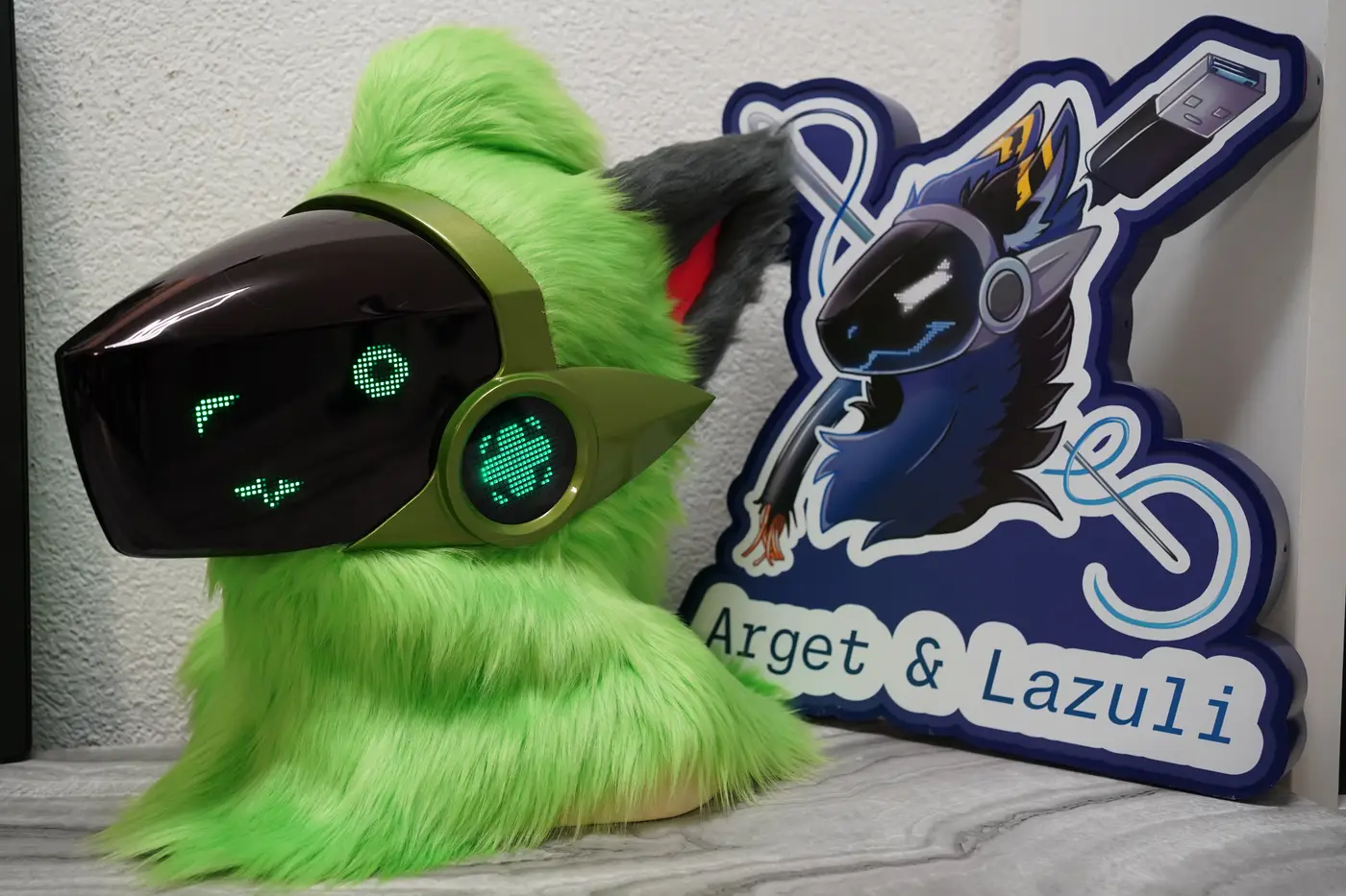 Lime green Protogen head with a round green pixel eye and a small pixel mouth on the black LED visor