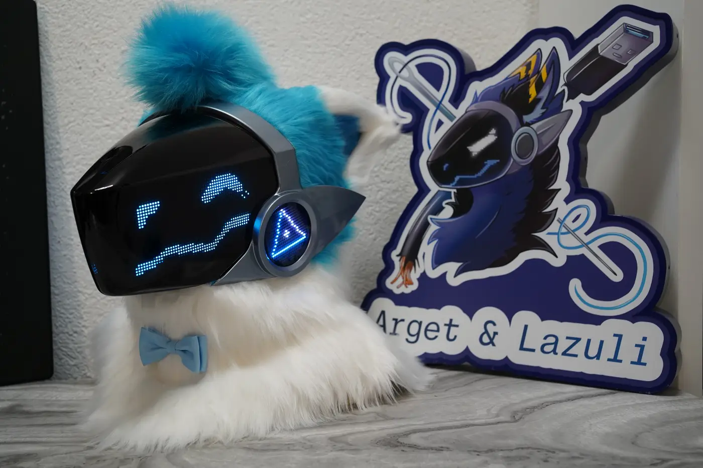 White Protogen head with arched blue pixel eyes and a curved pixel mouth on the LED visor