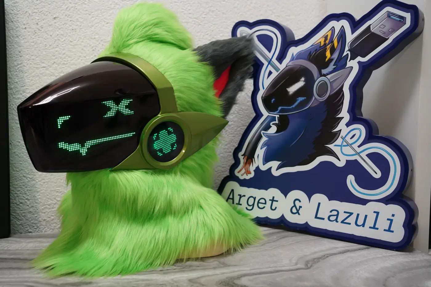 Lime green Protogen head with a green pixel X eye and a long flat mouth on the black LED visor