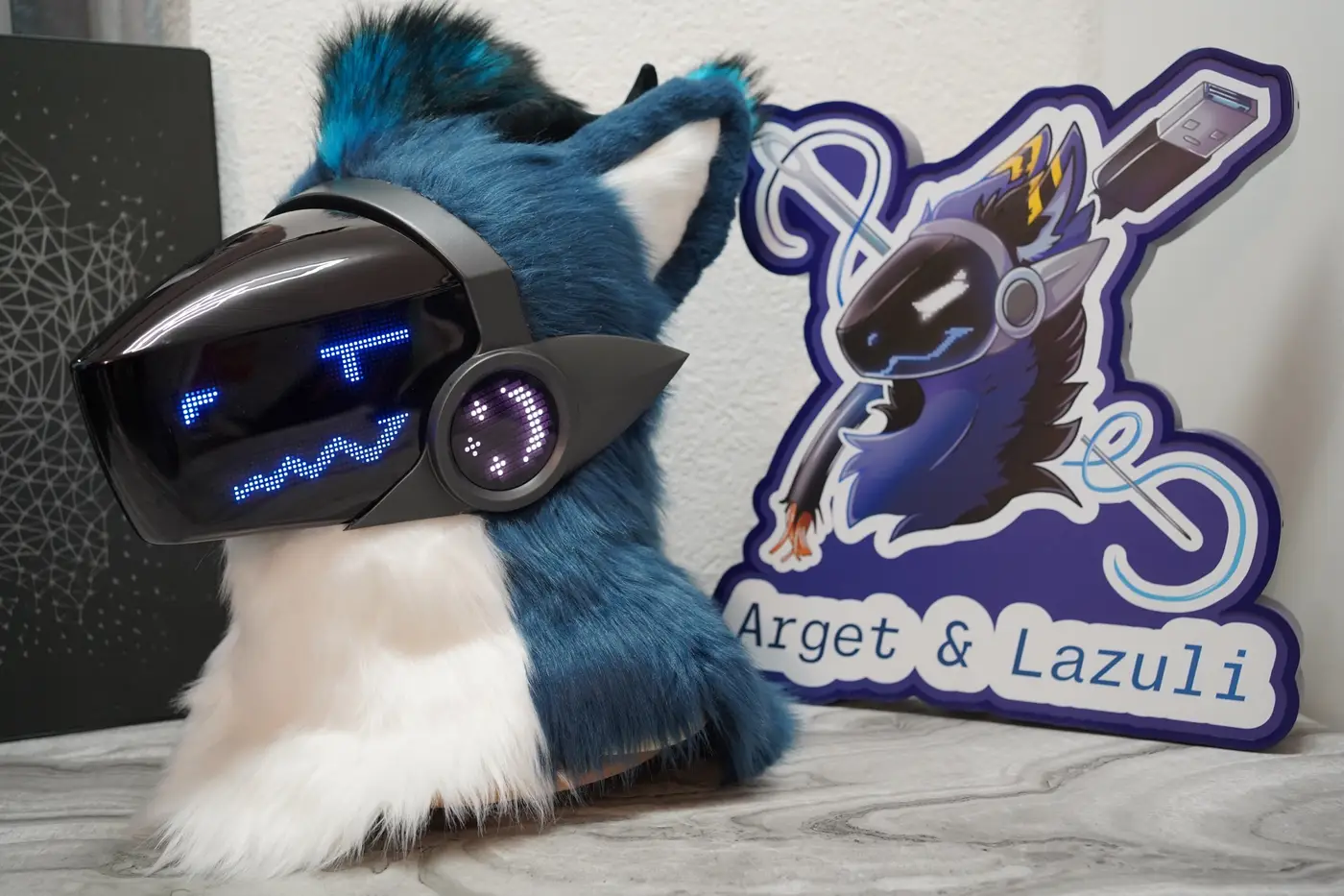 Blue Protogen head with small blue eyes and a curved mouth on the LED visor