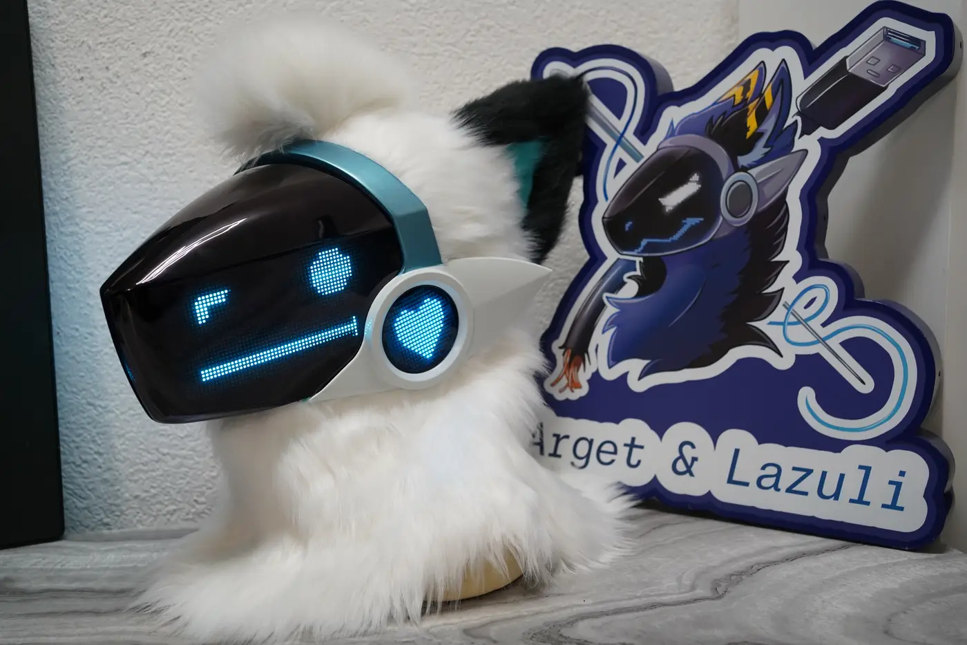 White Protogen head with a round cyan pixel eye and a straight pixel mouth on the black LED visor