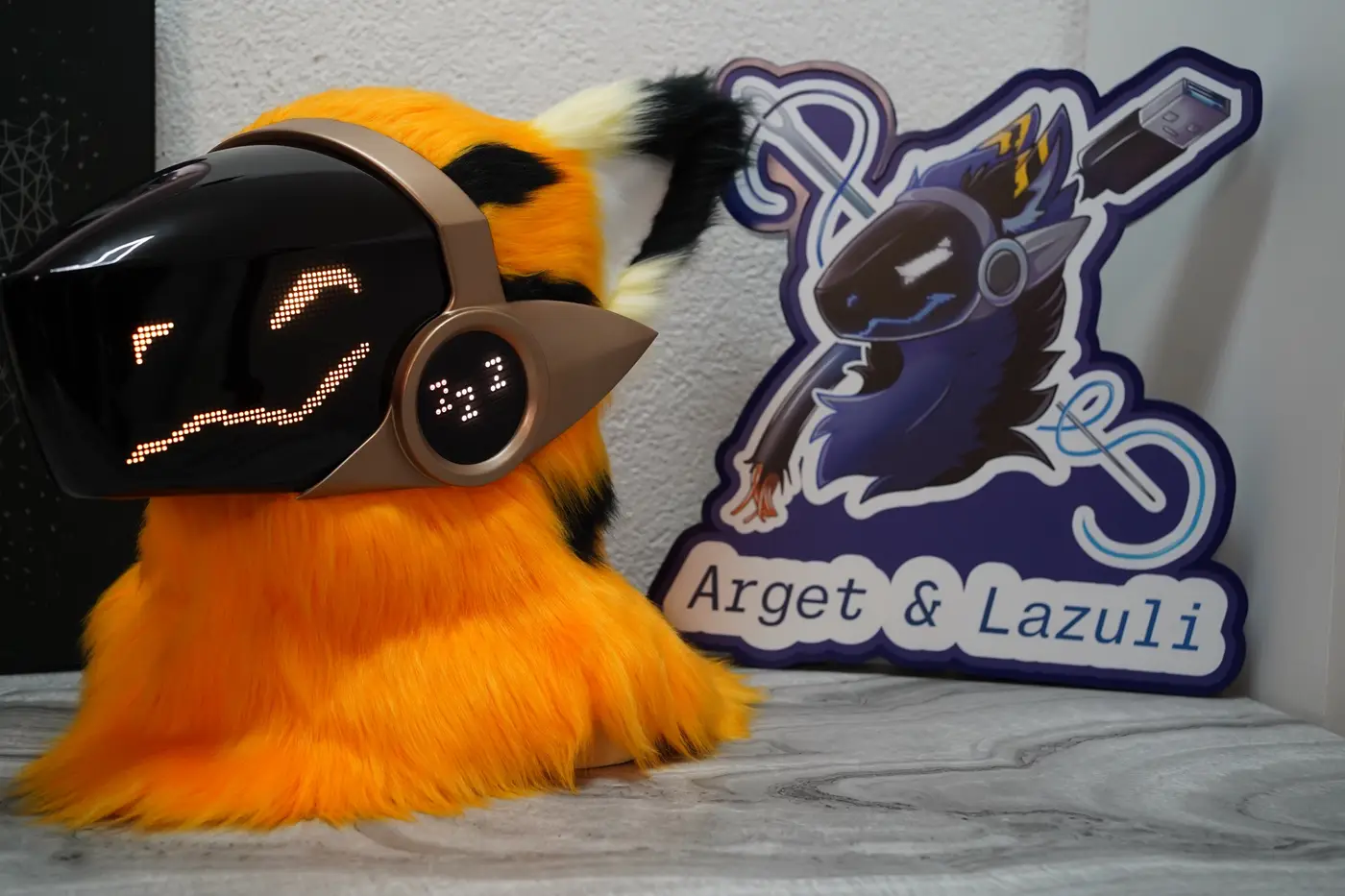 Orange Protogen head with a sleep symbol on the cheek disc beside the LED visor
