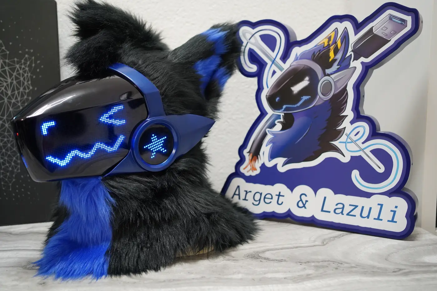 Black Protogen head with a blue square eye and a zigzag mouth on the LED visor