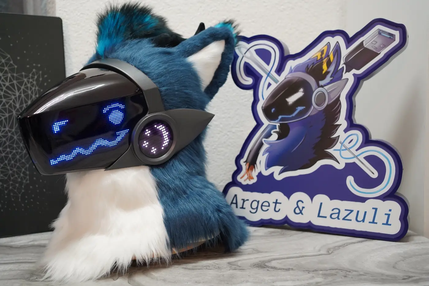 Blue Protogen head with one round blue eye and a straight mouth on the LED visor