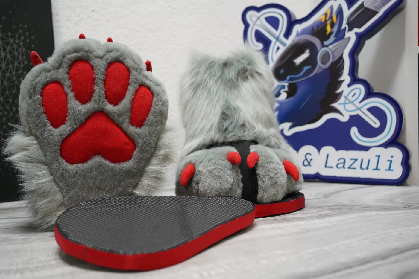 Gray Protogen feet paws with red paw pads and red claws on black outdoor sole sandals with a red edge