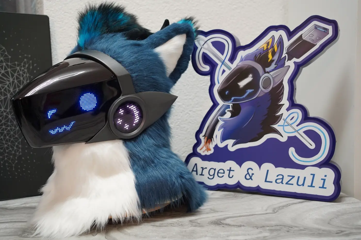 Blue Protogen head with narrow blue eyes and a zigzag mouth on the LED visor