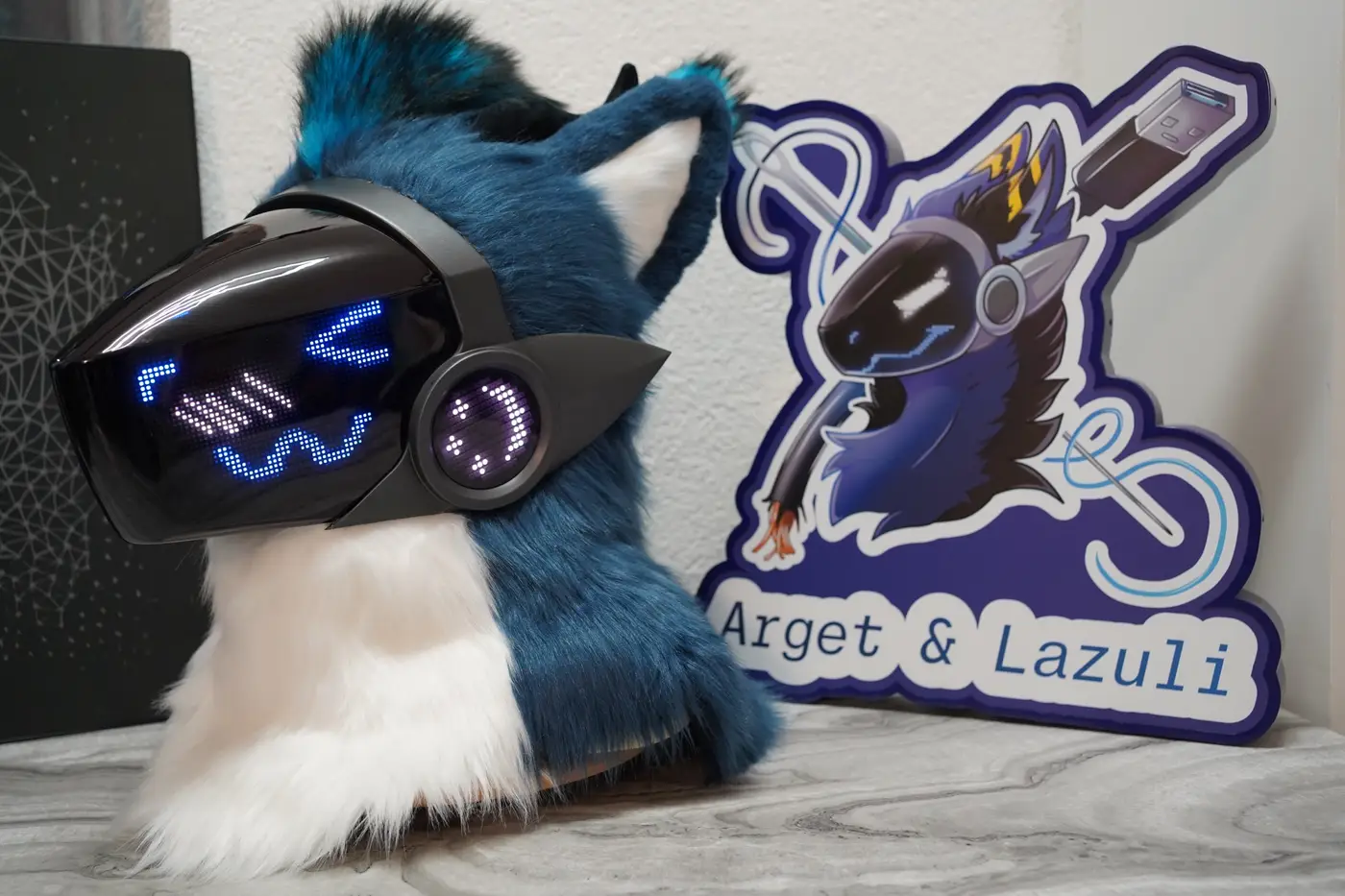 Blue Protogen head with a blue X over one eye on the LED visor