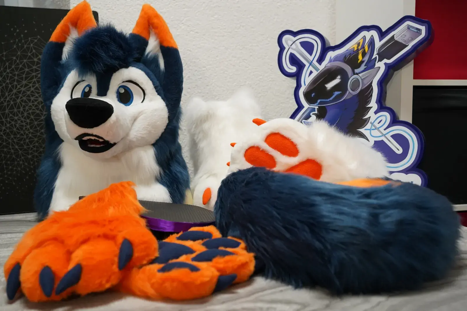 Navy blue, white and orange toony husky head with blue eyes and orange ear tips, matching hand paws and the Arget and Lazuli logo