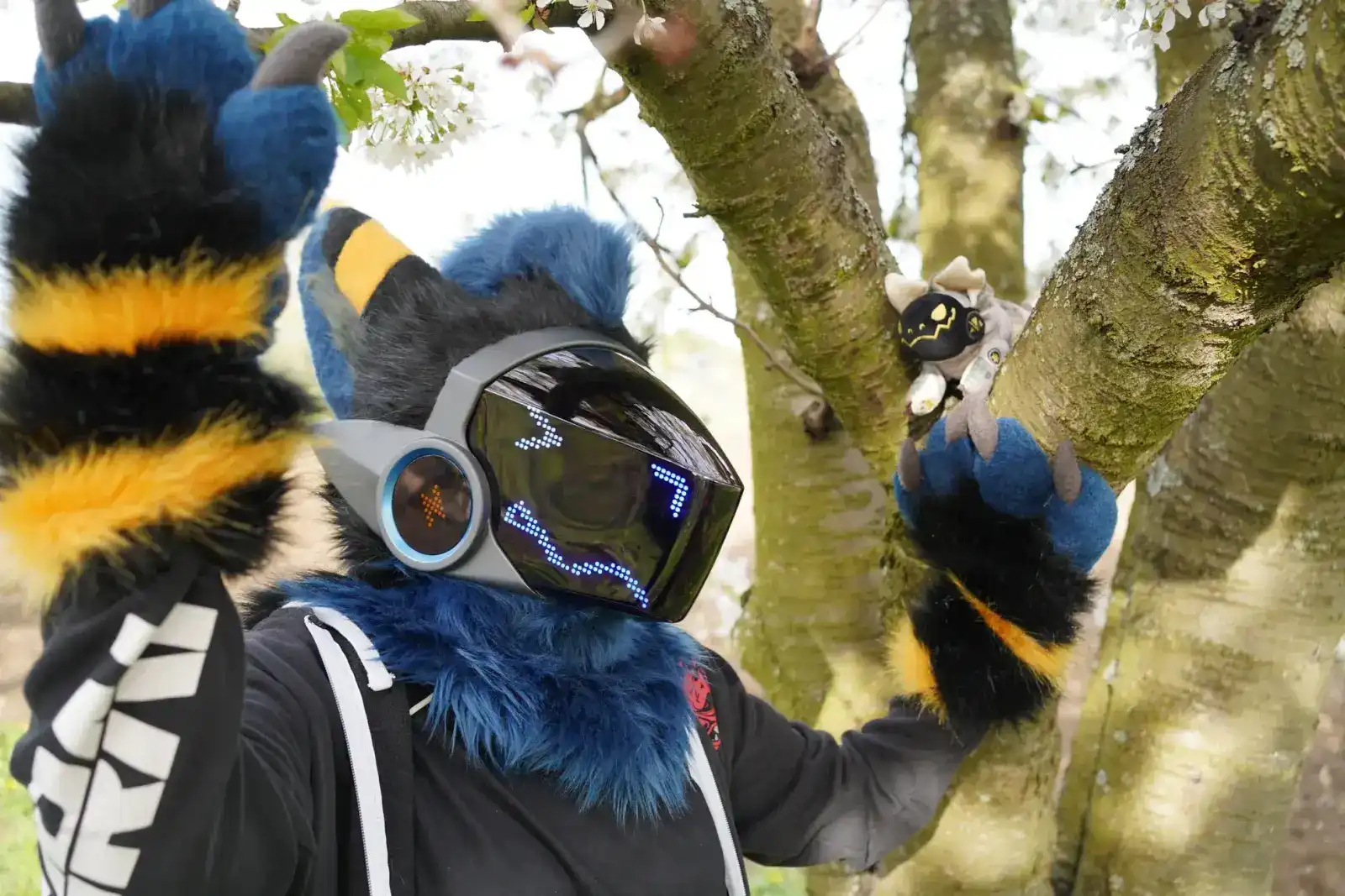 Blue, black and yellow Protogen partial with a striped tail, in a blossoming tree, by Arget & Lazuli